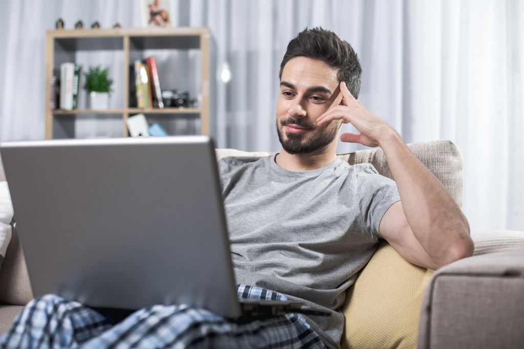 Man working on computer in jammies